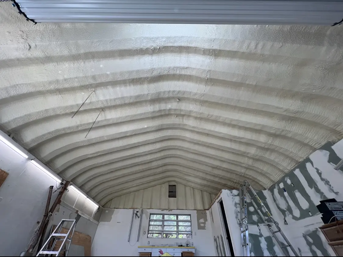 Spray polyurethane foam applied to the underside of a metal roof deck in Gretna